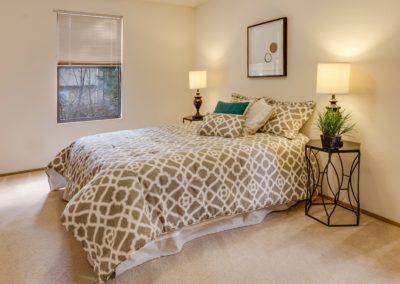 white-and-brown quatrefoil bedspread set on bed near window