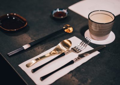 silver fork and bread knife on black table
